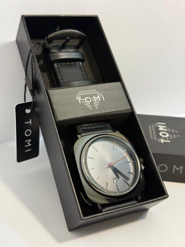 TOMI Watch with minimalist gray dial and red second hand in gift-ready packaging.