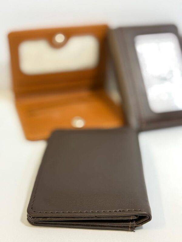 Compact leather wallet with a sleek design and snap closure.