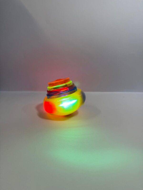 Close-up of colorful LED spinner tops with wind-up key.