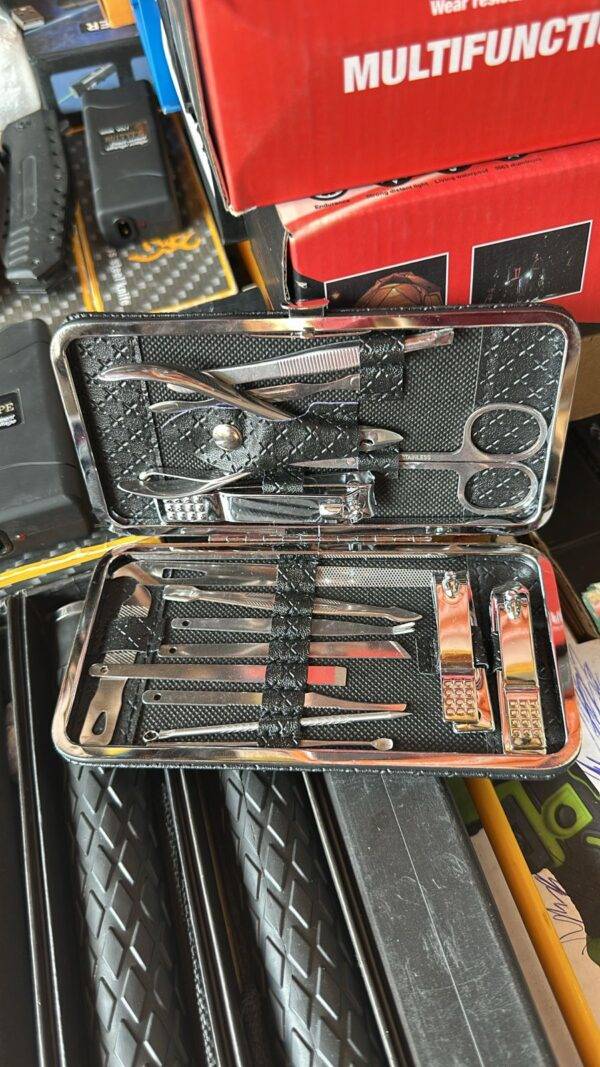 Open multifunctional grooming kit with various stainless steel tools neatly organized.