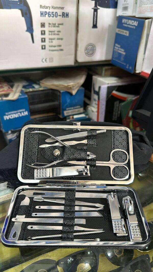 Full view of grooming kit with scissors, clippers, and other stainless steel tools.