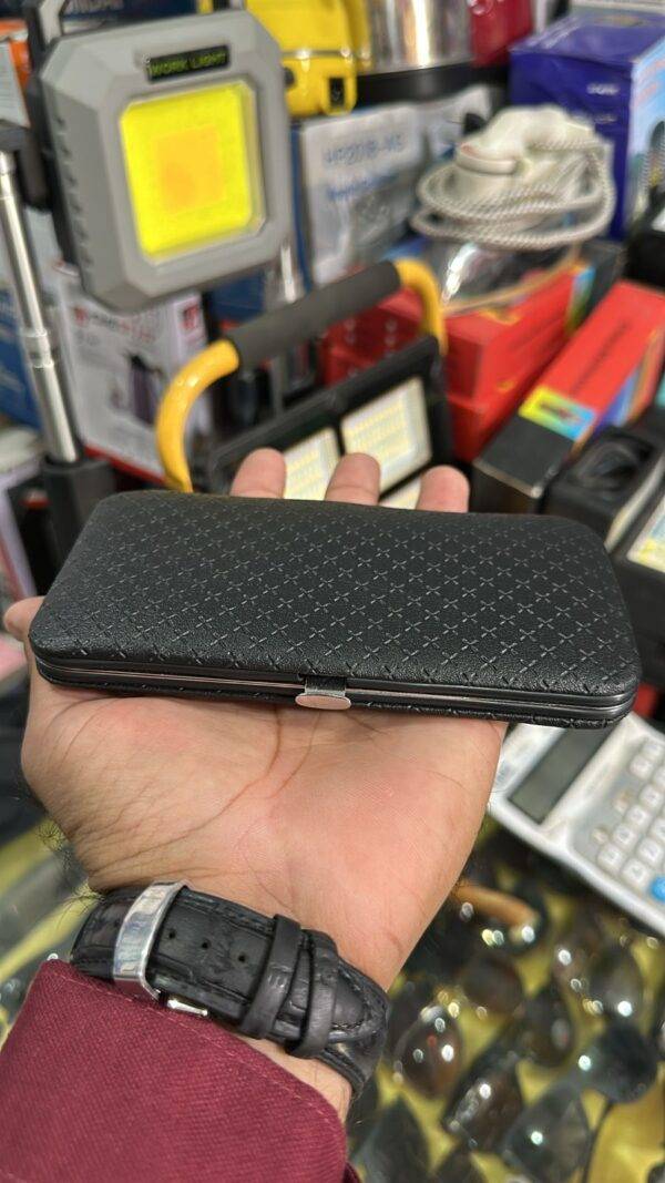 Side view of closed grooming kit in a textured black leather case.