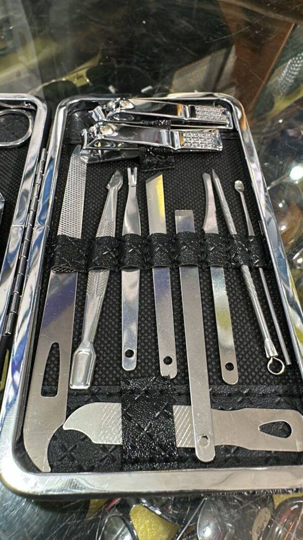 Individual stainless steel grooming tools laid out from the grooming kit.