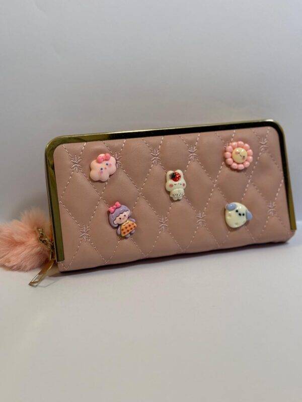 Angled view of the wallet showing the quilted pattern and character embellishments.