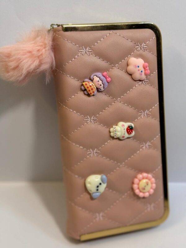 Close-up of the gold-toned zipper and fluffy pom-pom charm.