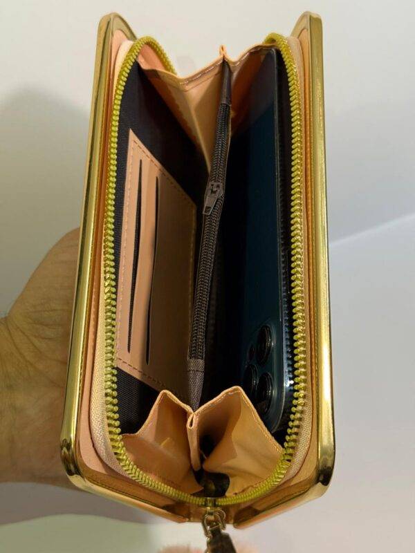 Hand holding the wallet to demonstrate size and portability.